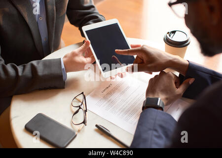 Close up shot of a tablet held by a man. Stock Photo