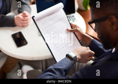 Close up of paperwork a man holds and reads. Stock Photo