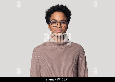 Headshot of black woman in glasses posing isolated in studio Stock Photo
