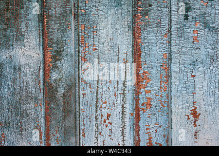 Vintage texture of old wooden door with cracking paint and chipping look. Antique background. Stock Photo