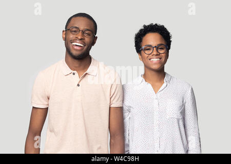 Smiling ethnic couple laugh posing for picture in studio Stock Photo