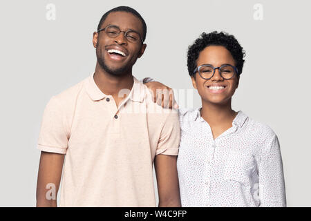 Smiling ethnic couple in glasses laugh posing for picture Stock Photo