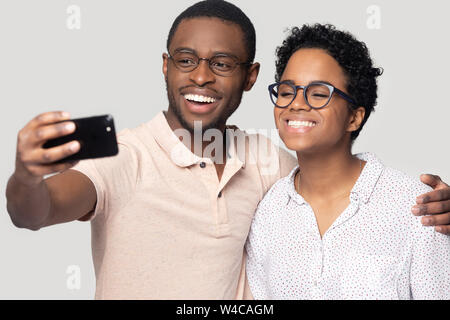 Smiling ethnic couple hug posing for selfie together Stock Photo