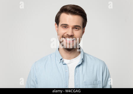 Headshot portrait of smiling guy isolated on grey studio background Stock Photo