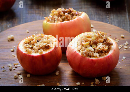 Appetizer baked stuffed apples on wooden table Stock Photo