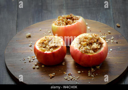 Baked apples on wooden board, healthy fruit dessert Stock Photo