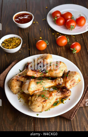 Baked chicken drumstick on white plate Stock Photo