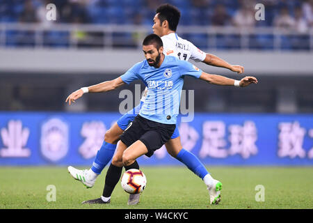 Belgian football player Yannick Ferreira Carrasco, front, of Dalian Yifang F.C. plays during the 19th round of Chinese Football Association Super League (CSL) against Tianjin TEDA in Tianjin, China, 20 July 2019. The match ended with a tie 3-3. Stock Photo