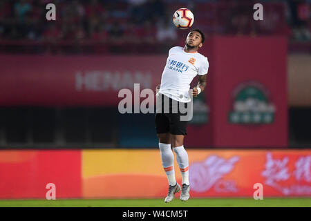 Brazilian football player Rafael Pereira da Silva, commonly known as Rafael or Rafael da Silva, of Wuhan Zall F.C. jumps to stop the ball during the 19th round of Chinese Football Association Super League (CSL) against Henan Jianye in Zhengzhou, central China’s Henan province on 21 July 2019. The match ened with a draw 0-0. Stock Photo