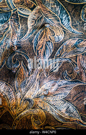 Closeup of patterned dark colorful sofa texture, leaf paintings on it Stock Photo