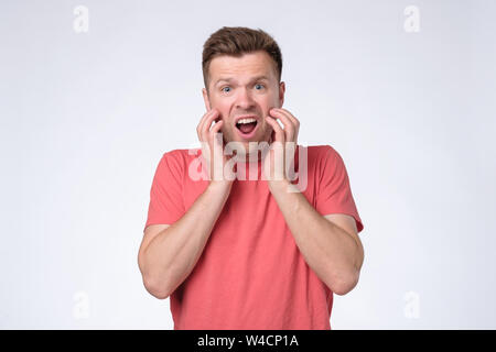 Miserable sad man being offended and upset expressing negative emotions. Stock Photo