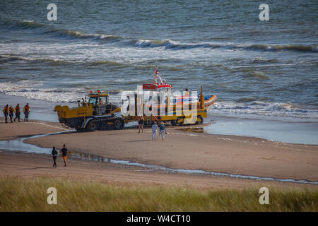 Egmond aan Zee, Netherlands - July 22, 2019: members of the dutch coastguard  lauch a lifeboat to the north sea for a rescue drill Stock Photo