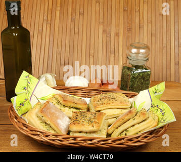 Laminar bread rolls with garlic and parsley in basket with decoration. Vintage style Stock Photo