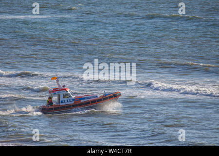 Egmond aan Zee, Netherlands - July 22, 2019: members of the dutch coastguard on a lifeboat on the north sea during a rescue drill Stock Photo