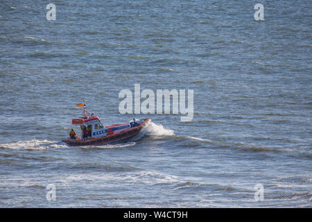 Egmond aan Zee, Netherlands - July 22, 2019: members of the dutch coastguard on a lifeboat on the north sea during a rescue drill Stock Photo