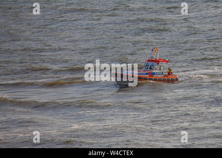 Egmond aan Zee, Netherlands - July 22, 2019: members of the dutch coastguard on a lifeboat on the north sea during a rescue drill Stock Photo