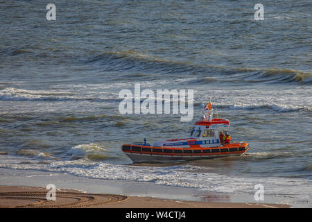 Egmond aan Zee, Netherlands - July 22, 2019: members of the dutch coastguard on a lifeboat on the north sea during a rescue drill Stock Photo