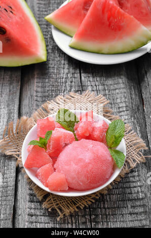 Watermelon ice cream with slices in white bowl Stock Photo