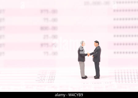 miniature people on business datar and shecking hand,business concept Stock Photo