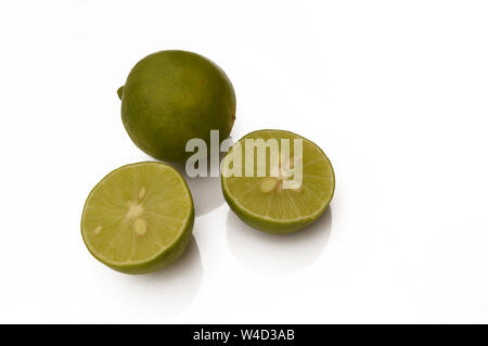 Fresh organic whole and sliced limes isolated on white background. Stock Photo