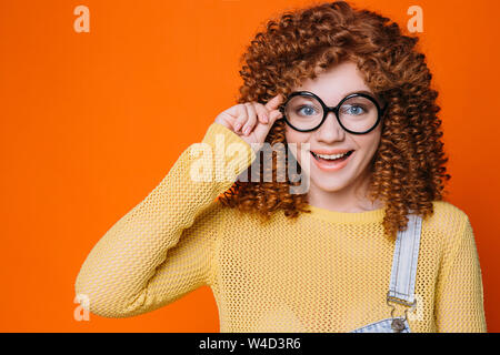 Smiling happy Student woman adjusting her eyeglasses Stock Photo