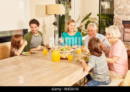 Family of three generations having lunch together at the big dining table Stock Photo