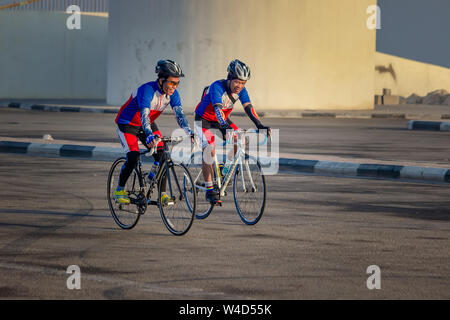 Two male cyclist cycling on their cycle in winter season. City: Dammam, country : Saudi Arabia.Photo taken month of December 22nd Year 2017. Stock Photo