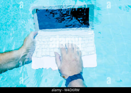 Male hands with a laptop working underwater. The concept of obstruction in the work. Blur Abstract Background. Stock Photo