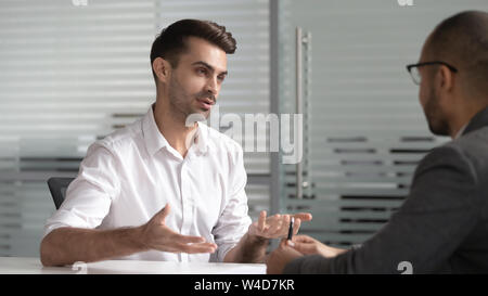 Serious male professional salesman consult customer at business meeting Stock Photo