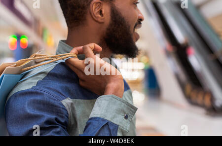 Close up of african guy with shopping bags looking straight Stock Photo
