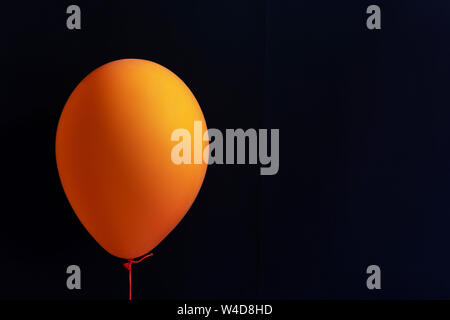 Autumn holidays decoration and party concept - scary air balloons for halloween over black background with copy space Stock Photo