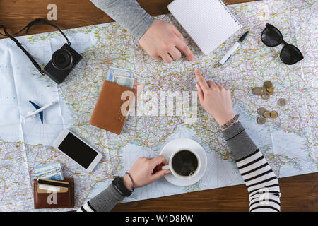 Advanced tourists searching new interesting trip on world map Stock Photo