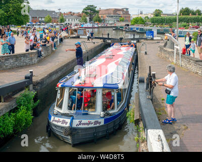 A barge navigates a canal lock in Stratford-upon-Avon. Stock Photo