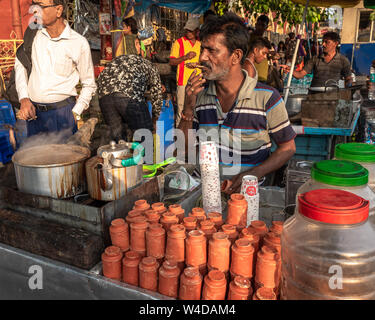 An unidentified Tea seller making and selling tea on the street of Kolkata. Stock Photo