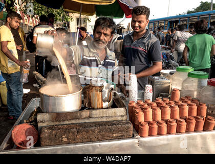 An unidentified Tea seller making and selling tea on the street of Kolkata. Stock Photo