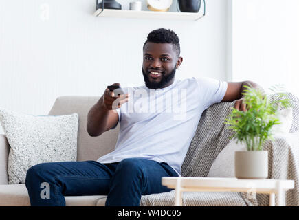 Young african american man watching TV at home Stock Photo