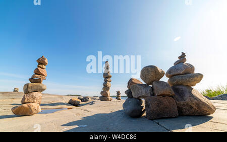 Stacked Rocks balancing, stacking with precision. Stone tower on the shore. Copy space. Stock Photo