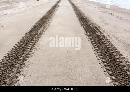 Tyre or tire tracks on the sand beach. Kamchatka, Russia. Close up image Stock Photo