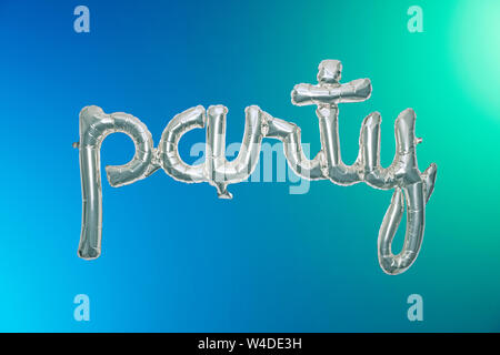 Metallic party balloon on a color blend backdrop Stock Photo