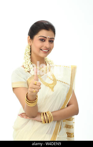 South Indian woman showing thumbs up sign and smiling Stock Photo - Alamy