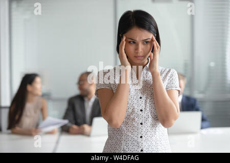 Stressed nervous asian business woman employee feel headache at work Stock Photo