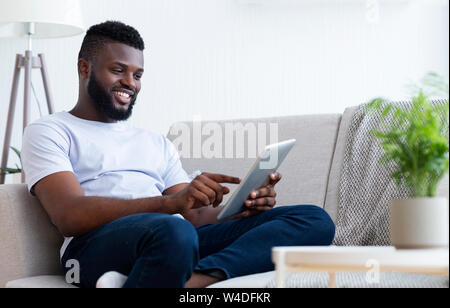 Young african american man using his digital tablet Stock Photo