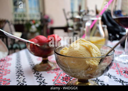 Vanilla and raspberry icecream - table covered with traditional tablecloth Stock Photo