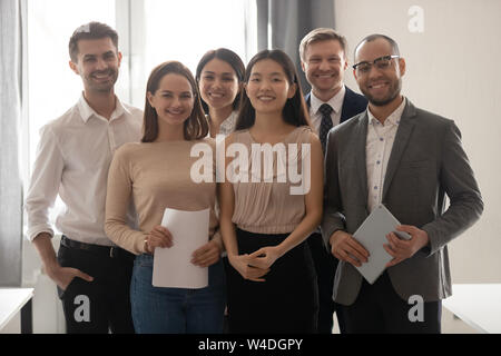 Multicultural professional work team happy employees group looking at camera Stock Photo