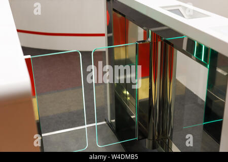 Automatic stainless steel waist height turnstile system. Selective focus. Stock Photo