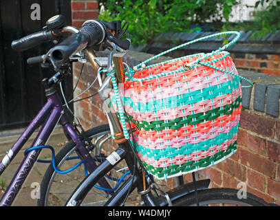 A brightly coloured front bicycle basket in the City centre of Norwich, Norfolk, England, United Kingdom, Europe. Stock Photo