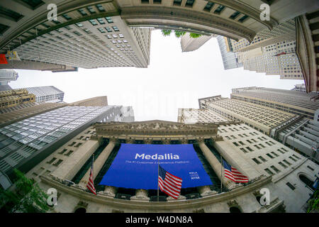 The New York Stock Exchange in Lower Manhattan in New York on Friday, July 19, 2019 is decorated with a banner for the Medallia initial public offering. Medallia is a customer experience company enabling its clients to quantify satisfaction (or dissatisfaction) generated.  (© Richard B. Levine) Stock Photo