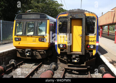 Two diesel multiple unit trains in bay platforms at Lancaster railway station on WCML, 22nd July 2019. A class 142 Pacer and class 156 super sprinter. Stock Photo