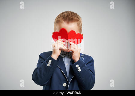 Portrait of happy cute little kid holding red heart Stock Photo