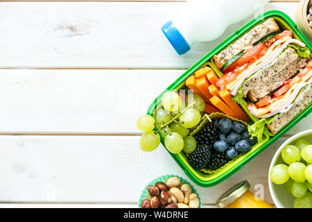 Back to school concept - lunch box with juice, apple and banana Stock Photo